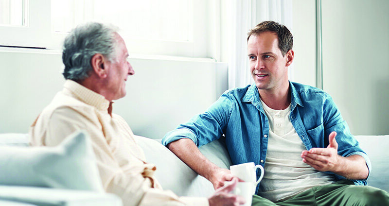 young-man-and-his-elderly-father-chating-over-coffee-on-sofa Personal transformation after 60